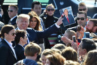 <p>President Donald Trump, third left, holds a photograph of himself while U.S. First Lady Melania Trump, fourth left, looks on as they greet attendees after arriving at U.S. Yokota Air Base in Fussa, Tokyo Metropolis, Japan, on Sunday, Nov. 5, 2017. (Photo: Kazuhiro Nogi/Pool via Bloomberg via Getty Images) </p>