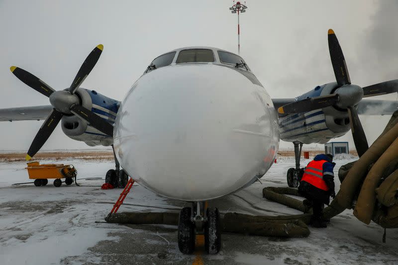 A Polar Airlines' Antonov An-24 passenger aircraft is serviced at an airport in Yakutsk