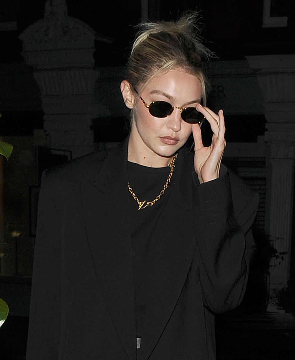 Gigi Hadid in sunglasses walking by paparazzi