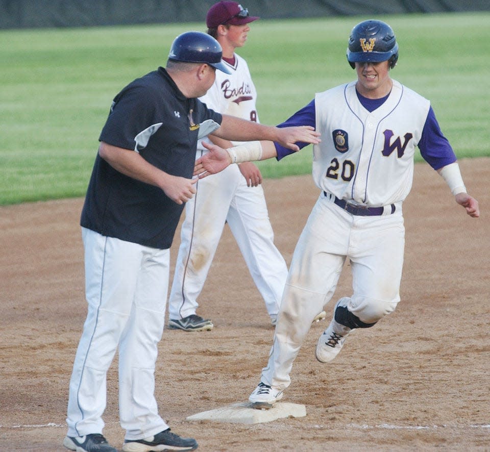 Watertown catcher Kolton Michalski is congratulated by head coach Matt Paulson after smacking a three-run homer during a 2014 American Legion Baseball game against Brookings at Watertown Stadium.