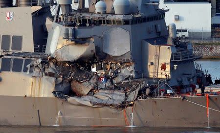 FILE PHOTO: The Arleigh Burke-class guided-missile destroyer USS Fitzgerald, damaged by colliding with a Philippine-flagged merchant vessel, is towed into the U.S. naval base in Yokosuka, south of Tokyo, Japan June 17, 2017. REUTERS/Toru Hanai/File Photo