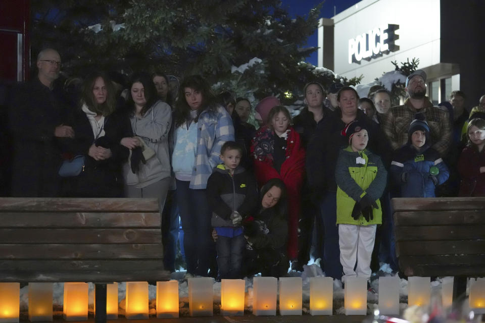 People attend a candlelight vigil after two police officers and a first responder were shot and killed Sunday, Feb. 18, 2024, in Burnsville, Minn. (AP Photo/Abbie Parr)