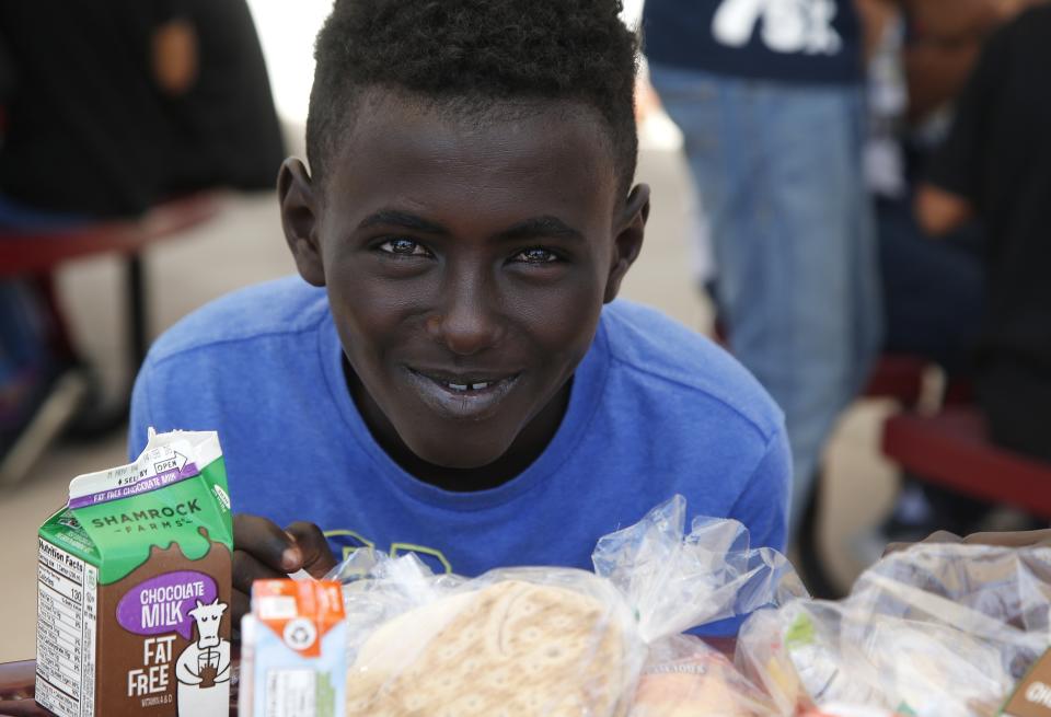 Student Ali Ali poses for a picture as he takes a break from eating lunch at Valencia Newcomer School Thursday, Oct. 17, 2019, in Phoenix. Children from around the world are learning the English skills and American classroom customs they need to succeed at so-called newcomer schools. Valencia Newcomer School in Phoenix is among a handful of such public schools in the United States dedicated exclusively to helping some of the thousands of children who arrive in the country annually. (AP Photo/Ross D. Franklin)