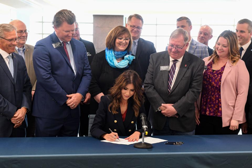 Governor Kristi Noem signs bills related to the creation of a new Dakota State University cybersecurity building on Thursday, March 24, 2022, at First Premier Bank in Sioux Falls.