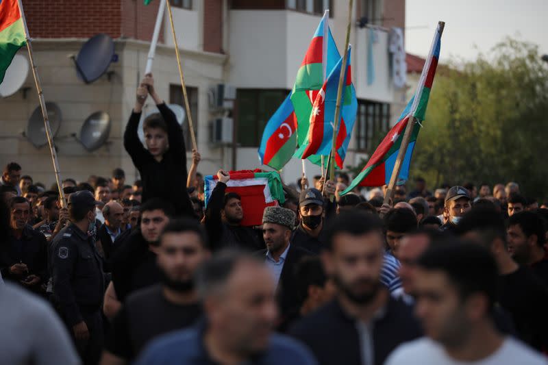 People carry the coffin of a member of Azerbaijani Armed Forces who was allegedly killed during the fighting over the breakaway region of Nagorno-Karabakh, in Tartar district