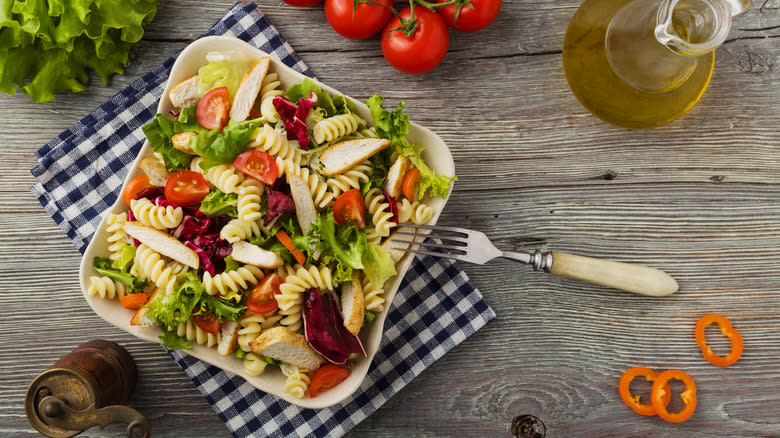 Pasta salad with chicken, tomatoes, and lettuce