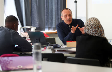 Students listen to teacher Manfred Wichmann in a classroom at the Europa-Berufsschule vocational school in Weiden, Germany, September 25, 2018. Picture taken September 25, 2018. REUTERS/Michael Dalder