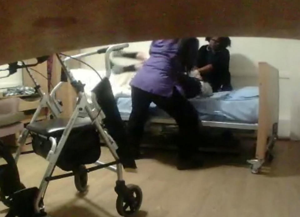 The shocking video shows nurse Mamello Herring and care worker Maria Jackson dragging Angelina Lanera from the toilet back to her bed using a banned "drag lift" technique. (SWNS)