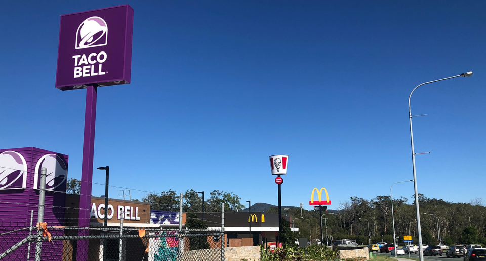 Shot from the street, we can see signs for a new Taco Bell, McDonald's and KFC in East Coomera.