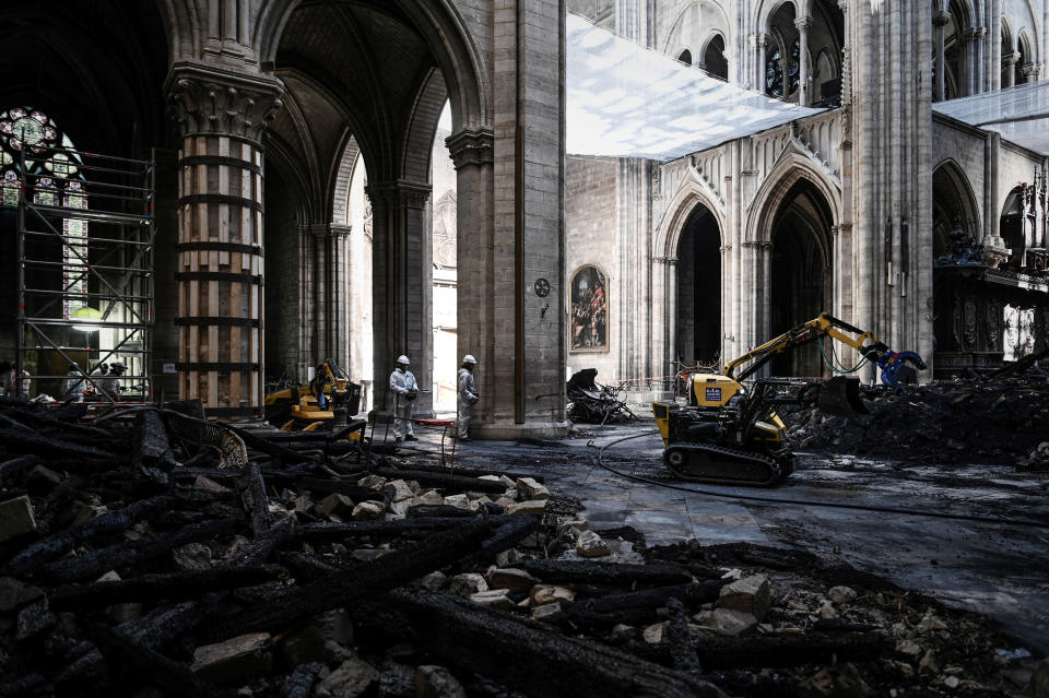 Workers stand near damages and rubble during preliminary work inside the Notre Dame de Paris Cathedral, May 15, 2019 in Paris. (Photo: Philippe Lopez/Pool via AP)          