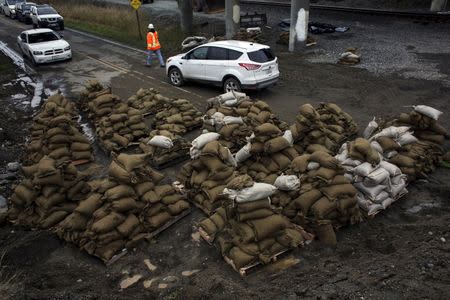 Sandbags for flood mitigation sit on a roadway near the flooded waters of the Stillaguamish River in Stanwood, Washington November 18, 2015. REUTERS/David Ryder