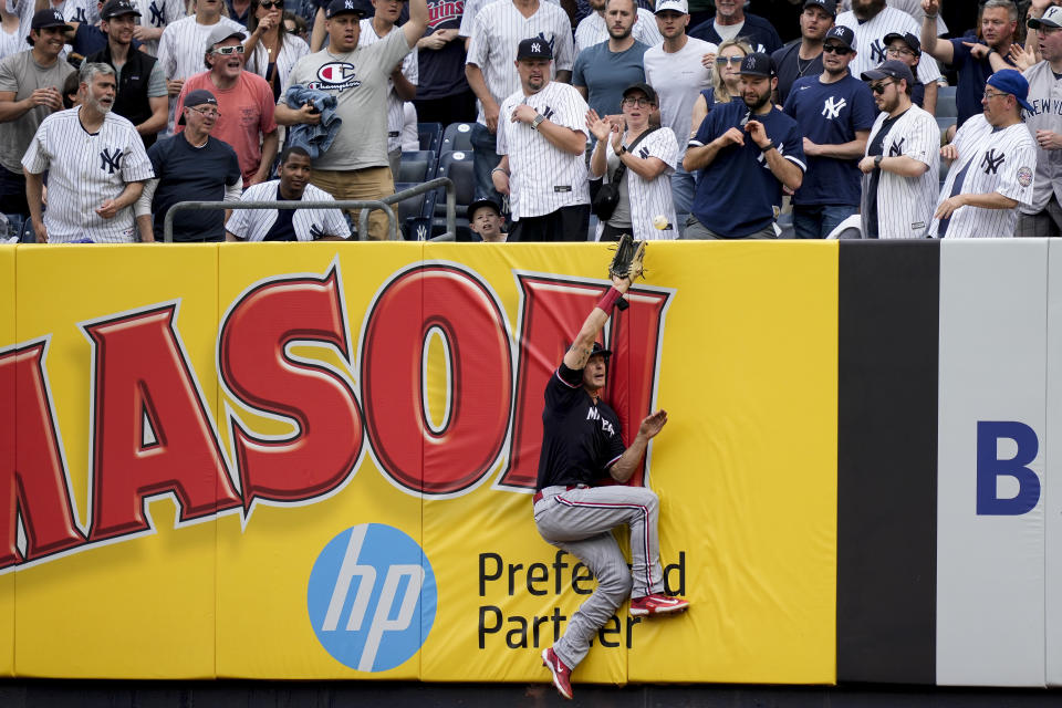 Minnesota Twins right fielder Max Kepler (26) misses the catch on a solo home run by New York Yankees' DJ LeMahieu in the sixth inning of a baseball game, Sunday, April 16, 2023, in New York. (AP Photo/John Minchillo)