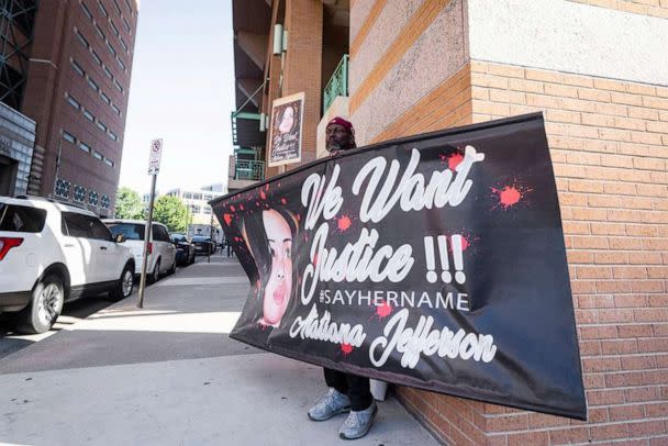 PHOTO: James Smith holds up a sign supporting justice for Atatiana Jefferson as a recusal hearing takes place on Judge David Hagerman's status in the Aaron Dean case, June 23, 2022, in Fort Worth, Texas.  (Yffy Yossifor/Fort Worth Star-Telegram/Tribune News Service via Getty Images)