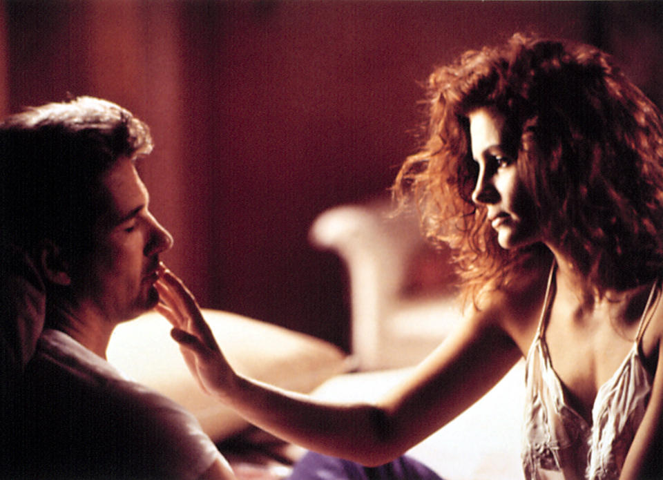 Julia Roberts reaching out to softly touch Richard Gere's lips with her fingertips in a scene from "Pretty Woman"