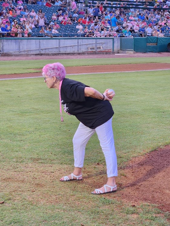 Cancer survivor Mary Ann Venable stares down the catcher, waiting for her "signature" pitch to be called, during "Paint the Park Pink" night, Aug. 5, at Smokies Stadium.