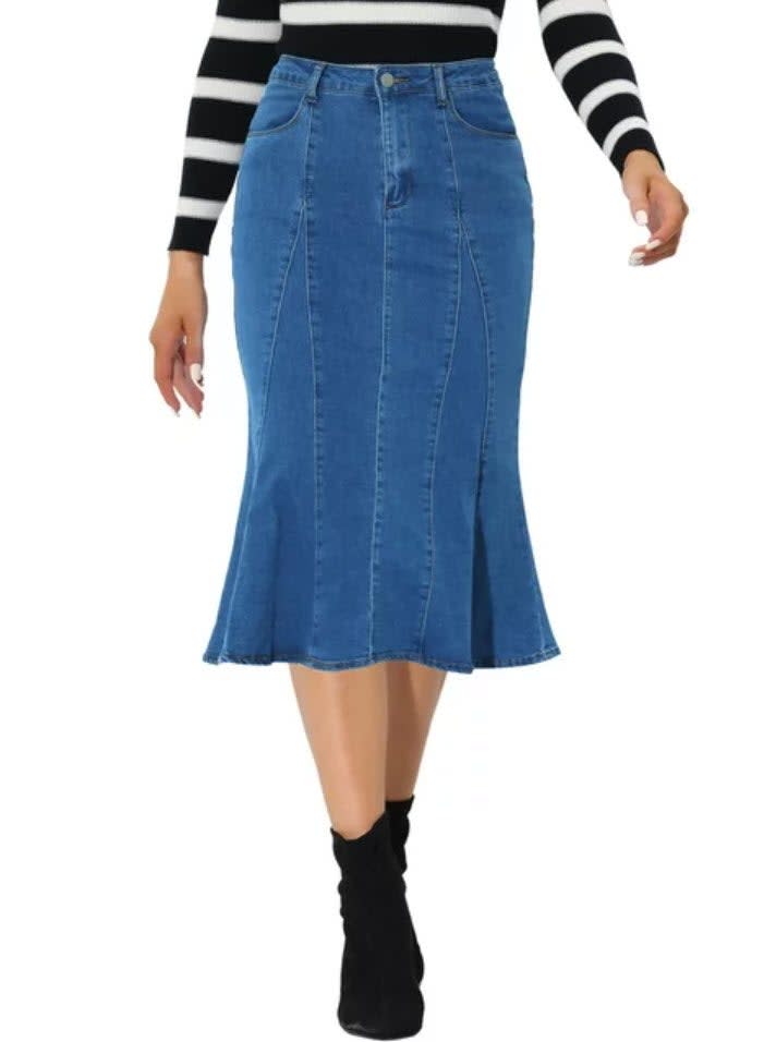 Person in a striped top and denim skirt with black boots, full-length skirt view