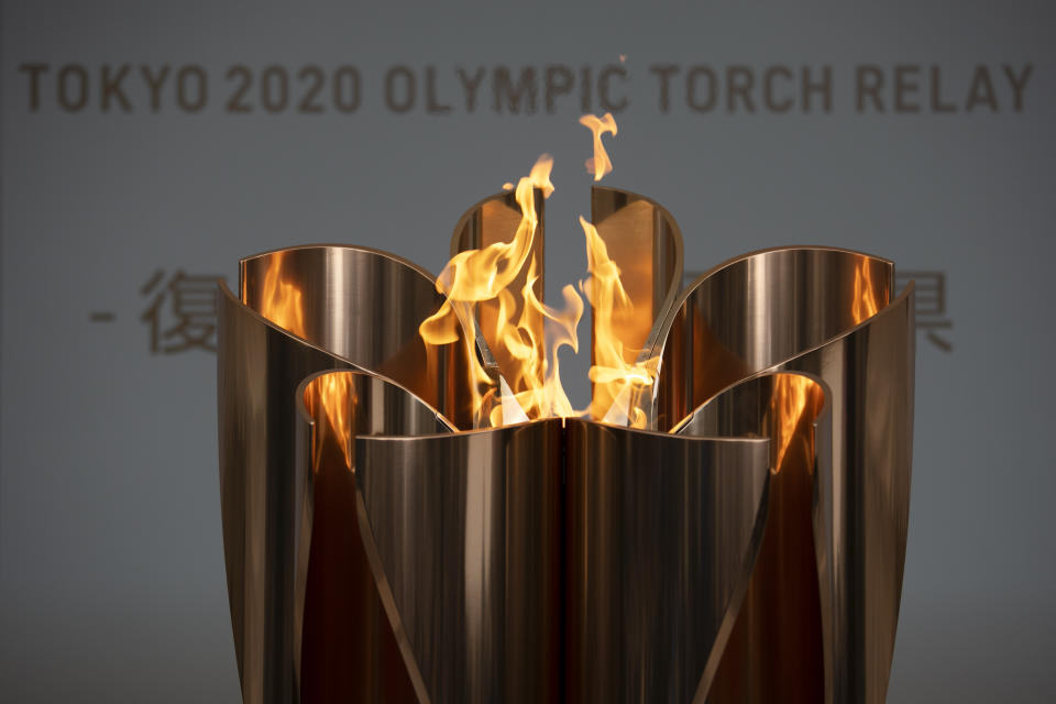 FILE - In this March 24, 2020, file photo, the Olympic Flame burns during a ceremony in Fukushima City, northern Japan. Tokyo Olympic organizers seem to be leaning away from starting the rescheduled games in the spring of 2021. More and more the signs point toward the summer of 2021. Organizing committee President Yoshiro Mori suggested there would be no major change from 2020. (AP Photo/Jae C. Hong)