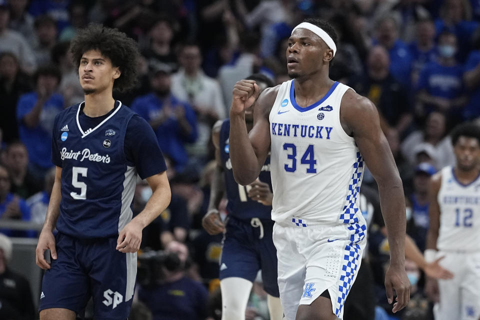 Kentucky forward Oscar Tshiebwe (34) celebrates in front of Saint Peter's guard Daryl Banks III (5) after making a basket during the second half of a college basketball game in the first round of the NCAA tournament, Thursday, March 17, 2022, in Indianapolis. (AP Photo/Darron Cummings)