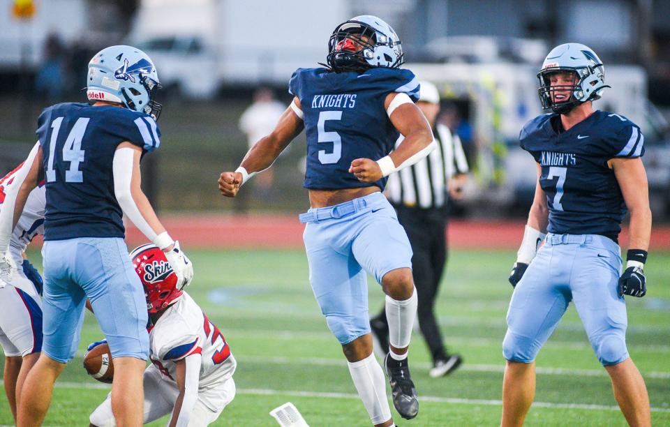 North Penn's Christian Johns-Wallace, 5, celebrates his shared tackle with teammate Aidan Eves, 7, against Neshaminy during their football game in Lansdale on Friday, Sept. 13, 2024.