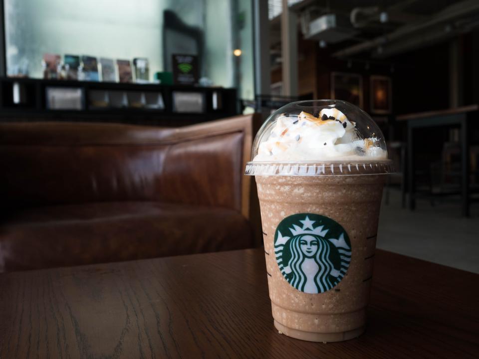 Starbucks Frappuccino sitting on a wood coffee table