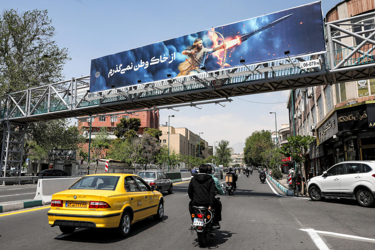 A banner depicting the mythical Persian hero Arash the archer firing a missile from his bow, with text in Persian reading 