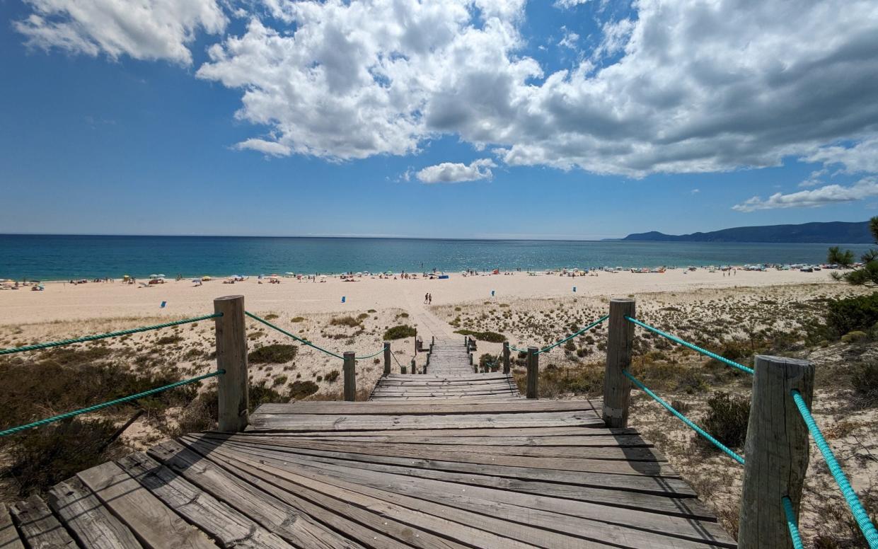 Wooden steps leading down to the sea at Praia Atlantica