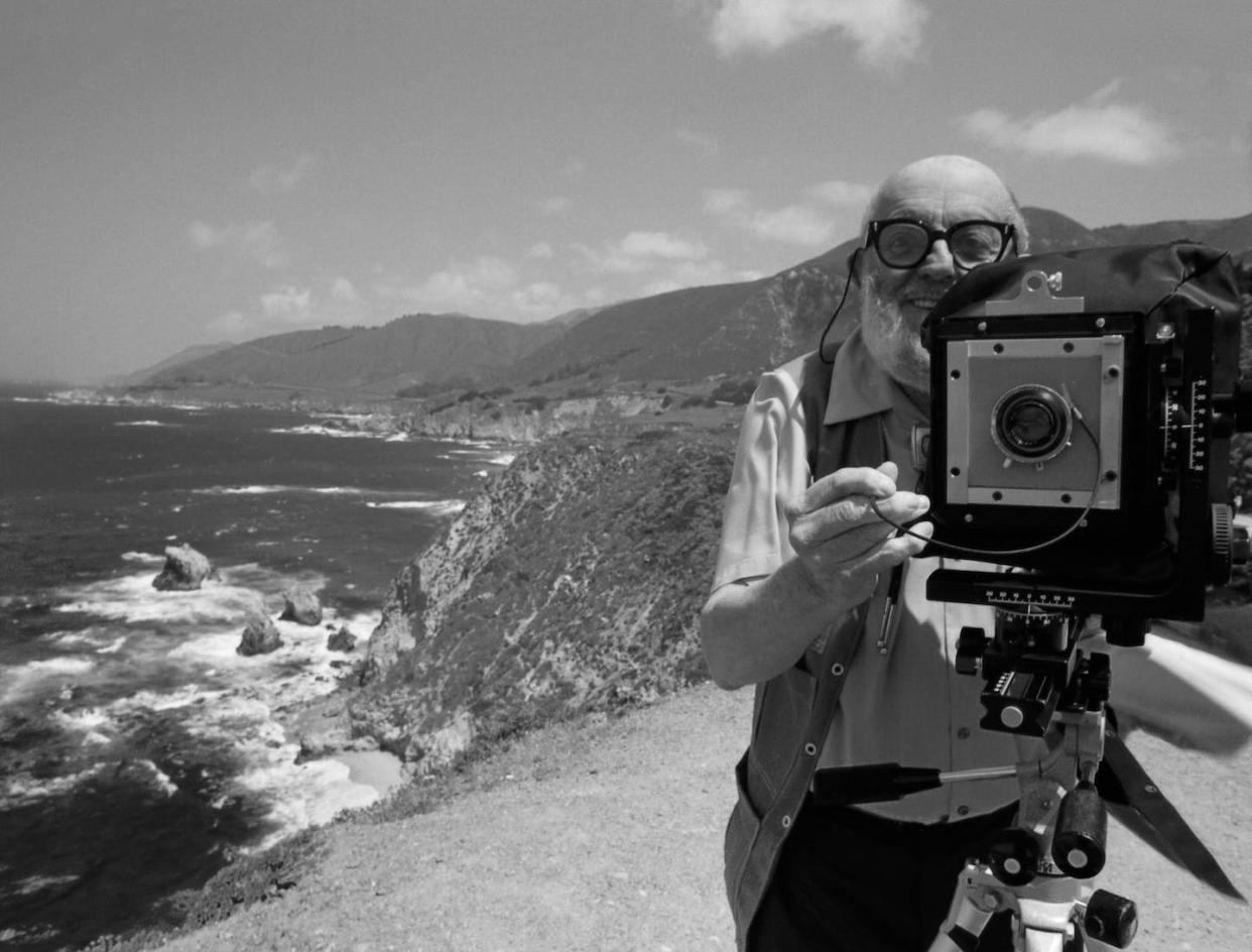 Photographer Ansel Adams poses on a bluff with his camera. <a href="https://www.gettyimages.com/detail/news-photo/photographer-ansel-adams-stands-on-a-bluff-above-the-news-photo/929127942?adppopup=true" rel="nofollow noopener" target="_blank" data-ylk="slk:Roger Ressmeyer/CORBIS/VCG via Getty Images;elm:context_link;itc:0;sec:content-canvas" class="link ">Roger Ressmeyer/CORBIS/VCG via Getty Images</a>