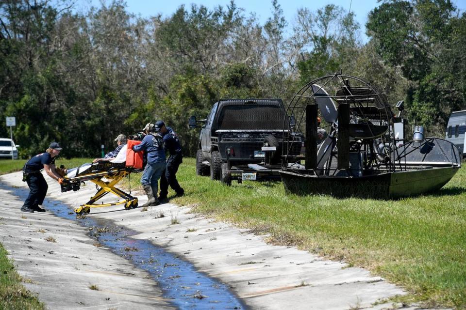 DeSoto County Fire Rescue moves a man on a stretcher to be transported by airboat across a flooded area of S.R. 70 in an area flooded by the Peace River in Arcadia on Sept. 30, 2022.