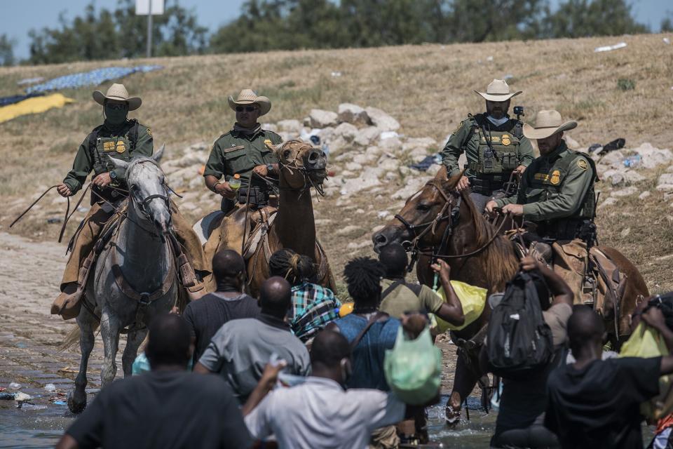 Customs and Border Protection mounted officers attempt to contain mostly migrants as they cross the Rio Grande from Ciudad AcuÒa into Del Rio, Texas, . Thousands of Haitian migrants have been