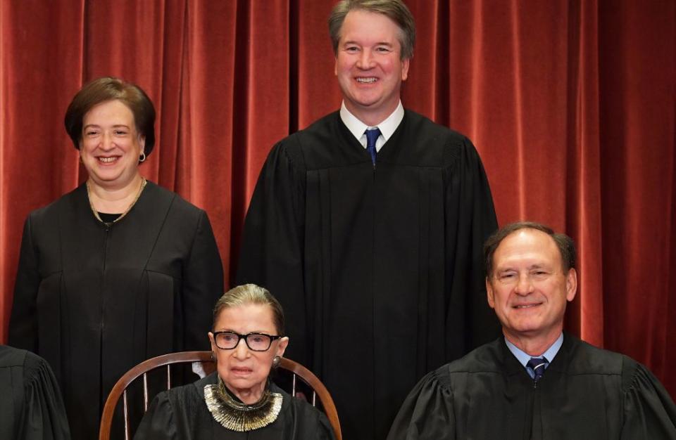 Associate Justice Elena Kagan (left, rear) and Associate Justice Brett Kavanaugh (center, rear), Associate Justice Ruth Bader Ginsburg (center, front) and Associate Justice Samuel Alito pose for an Supreme Court official group photo on November 30, 2018. (Photo by MANDEL NGAN / AFP via Getty Images)