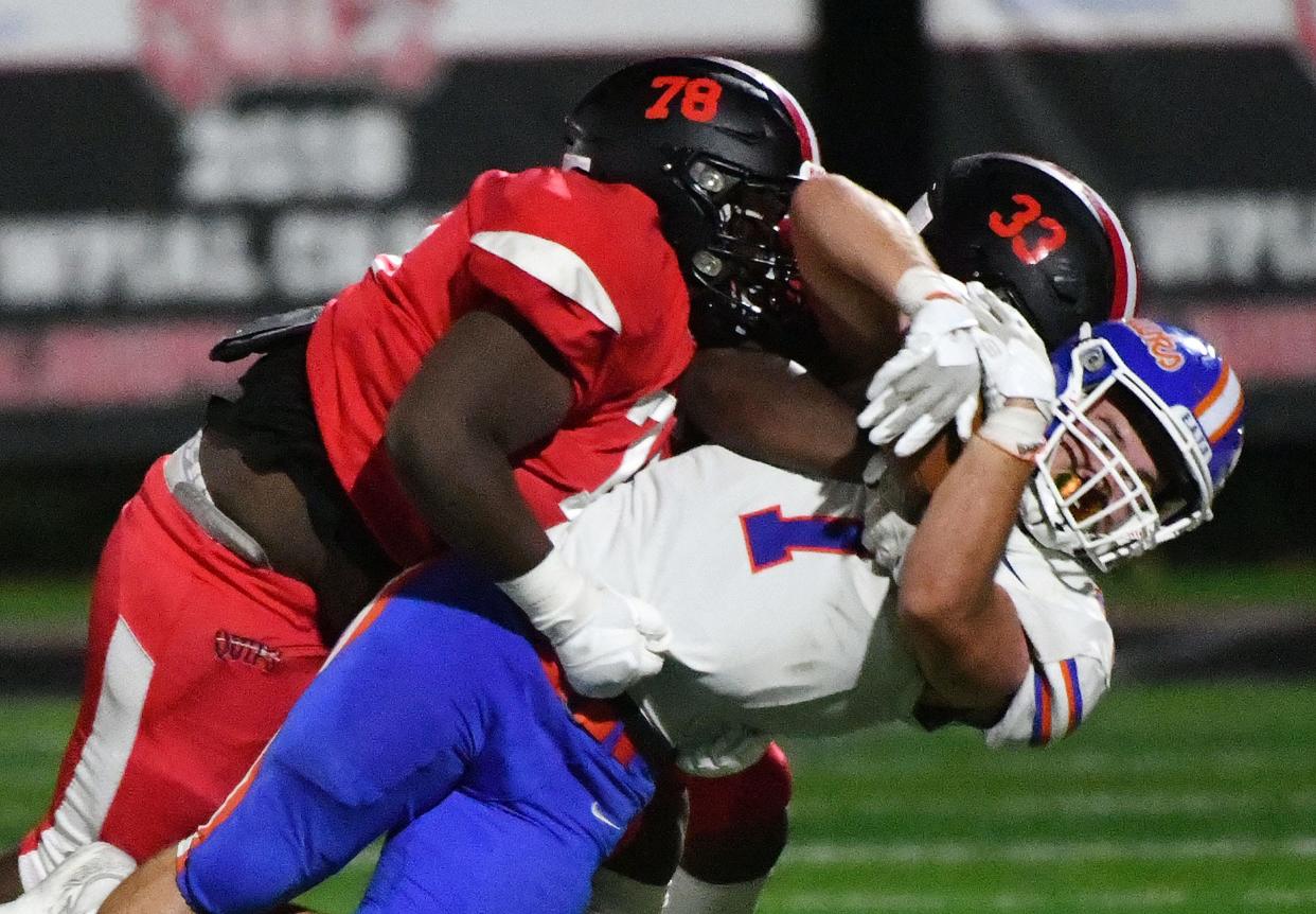 AliquippaÕs Devon Humphries and Jayace Williams tackle Armstrong's Alex Patton during Friday night's game at AliquippaÕs new stadium, Heinz Field.