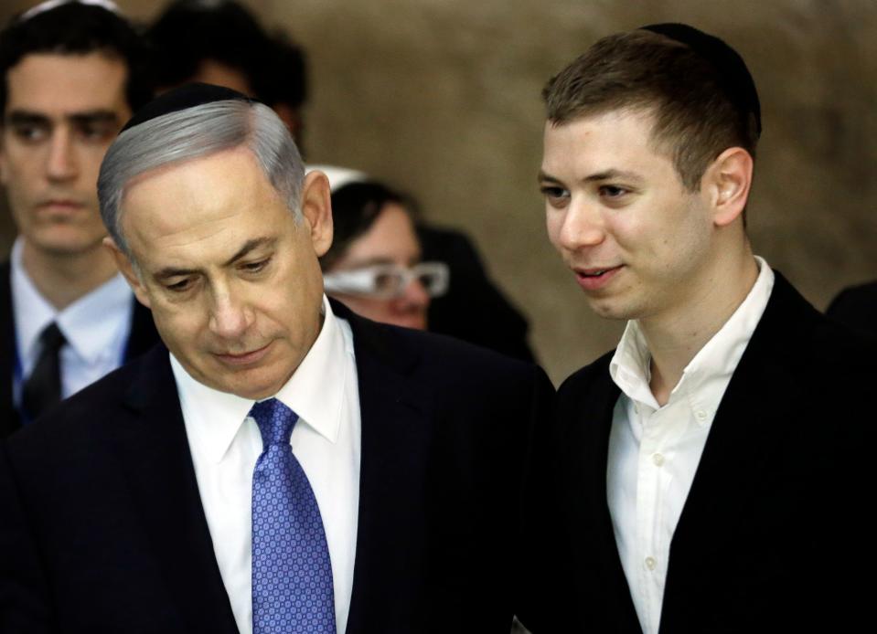 Prime Minister Benjamin Netanyahu, left, and his son Yair visiting the Western Wall in Jerusalem on March 18, 2015. The younger Netanyahu faced online criticism on Sept. 9, 2017, after sharing an image on his Facebook page deemed anti-Semitic by critics. (Photo: Thomas Coex/AFP/Getty Images)