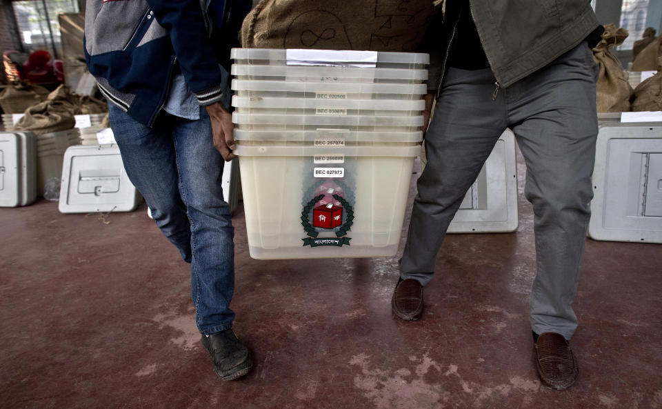 Bangladeshi election officials carry voting material at a distribution center before being transported to different polling stations on the eve of the general elections in Dhaka, Bangladesh, Saturday, Dec. 29, 2018. As Bangladeshis get set for Sunday's parliamentary elections, there are fears that violence and intimidation could keep many away from the polls, including two opposition candidates who said police had barricaded them inside their homes. (AP Photo/Anupam Nath)