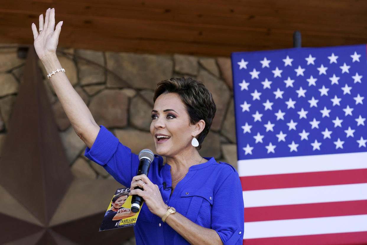 Republican gubernatorial candidate Kari Lake waves to supporters at a campaign event in Queen Creek, Ariz., Wednesday, Oct. 5, 2022. Lake will face Democrat Katie Hobbs in the general election in November. (AP Photo/Ross D. Franklin)
