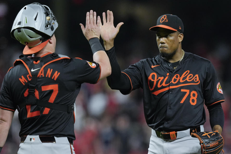 Baltimore Orioles pitcher Yennier Cano (78) celebrates with catcher James McCann (27) after winning a baseball game against the Cincinnati Reds on Saturday, May 4, 2024, in Cincinnati. (AP Photo/Carolyn Kaster)