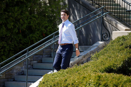 Canada's Prime Minister Justin Trudeau walks outside the Manoir Richelieu, site of the upcoming G7 leaders' summit in Quebec's Charlevoix region, before the start of an interview with Reuters in La Malbaie, Quebec, Canada, May 24, 2018. REUTERS/Chris Wattie