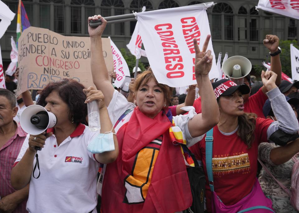 Supporters of Peru's President Pedro Castillo rally outside congress where lawmakers voted to proceed with impeachment proceedings against Castillo, in Lima, Peru, Monday, March 28, 2022. (AP Photo/Martin Mejia)