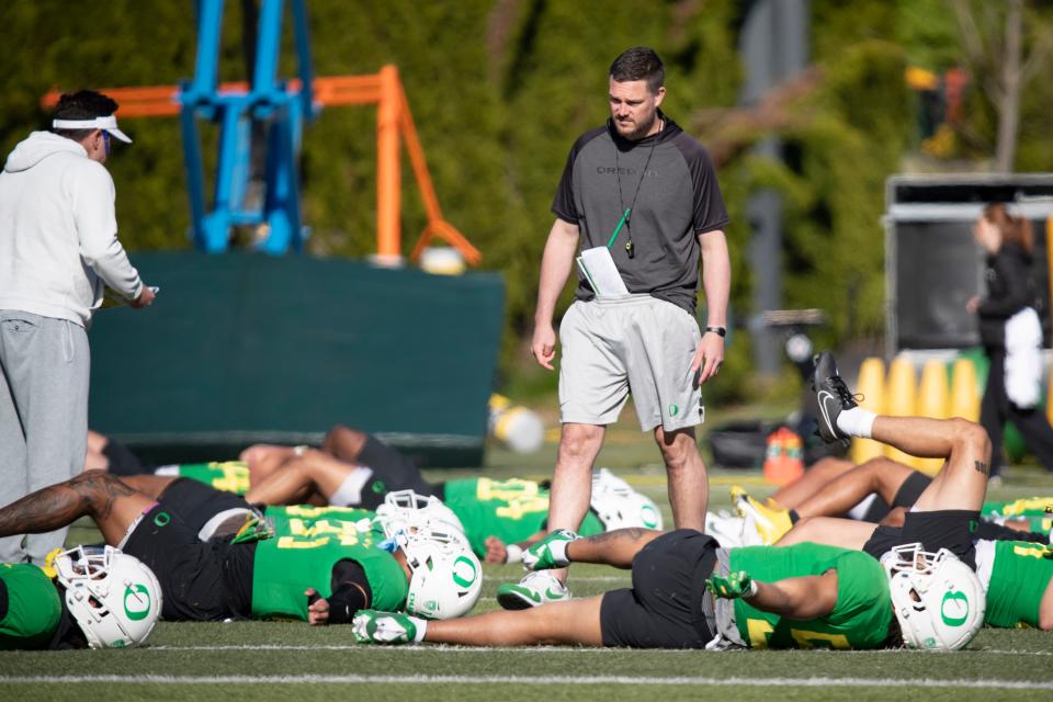 Oregon head coach Dan Lanning walks the field during practice with the Ducks April 18 at the Hatfield-Dowlin Complex in Eugene.