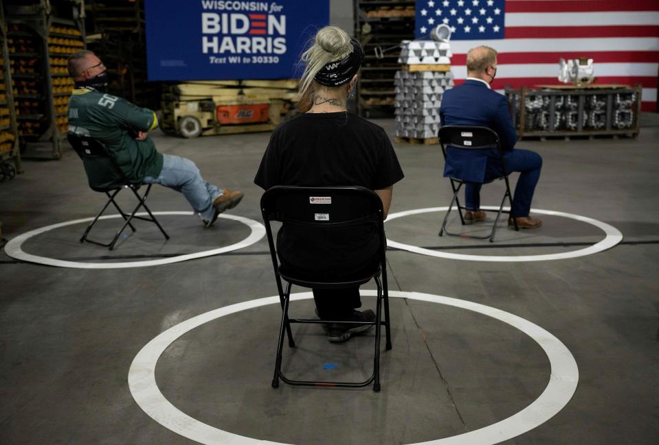 People social distance as Democratic Presidential Candidate Joe Biden delivers remarks at an aluminum manufacturing facility in Manitowoc, Wisconsin, on September 21, 2020.