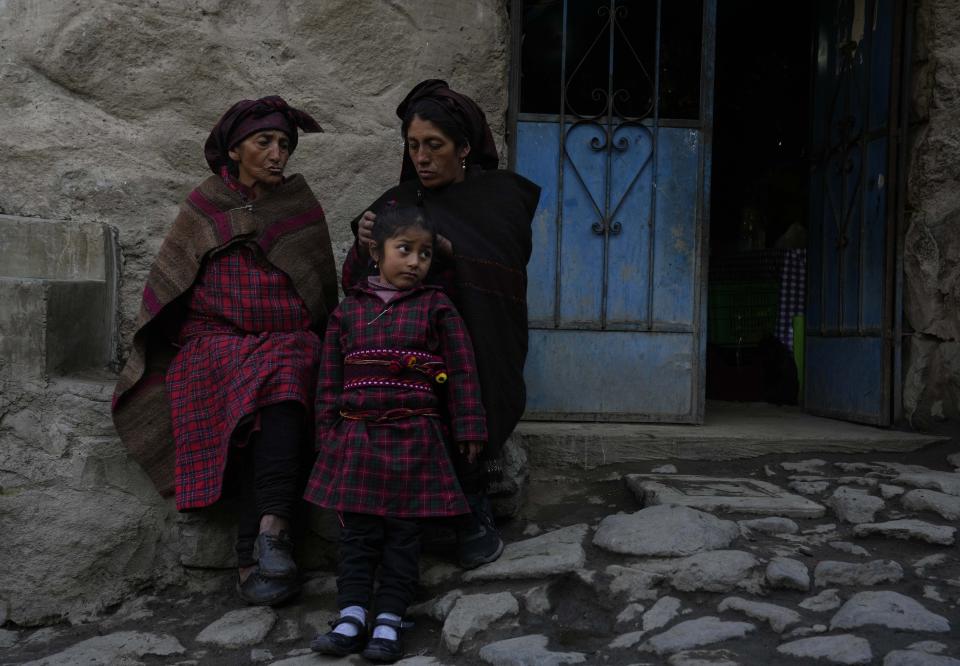 Women visit while combing a girl's hair in Tupe, Peru, Tuesday, July 19, 2022. As Peru´s President Pedro Castillo marks the first anniversary of his presidency, his popularity has been decimated by his chaotic management style and corruption allegations, but in rural areas like Tupe, voters believe the fault for the executive crisis lies not only with Castillo, but with Congress, which has sought to remove him twice. (AP Photo/Martin Mejia)