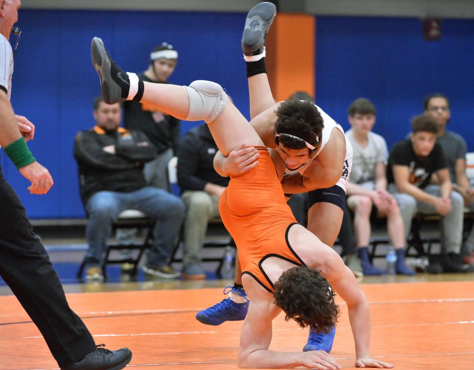 McDowell's Artis Simmons, top, and Cathedral Prep's Bo Martucci compete at 152 pounds during the District 10 Class 3A team wrestling tournament at Prep's Hagerty Family Events Center in Erie on Feb. 2. Simmons is one of four Trojans heading to this week's PIAA 3A tournament.