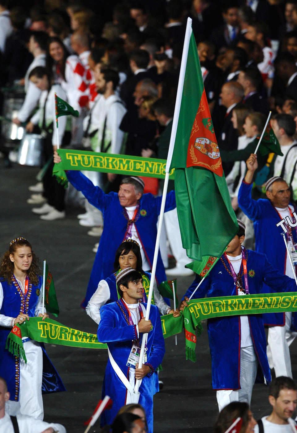 LONDON, ENGLAND - JULY 27: Serdar Hudayberdiyev of the Turkmenistan Olympic boxing team carries his country's flag during the Opening Ceremony of the London 2012 Olympic Games at the Olympic Stadium on July 27, 2012 in London, England. (Photo by Laurence Griffiths/Getty Images)