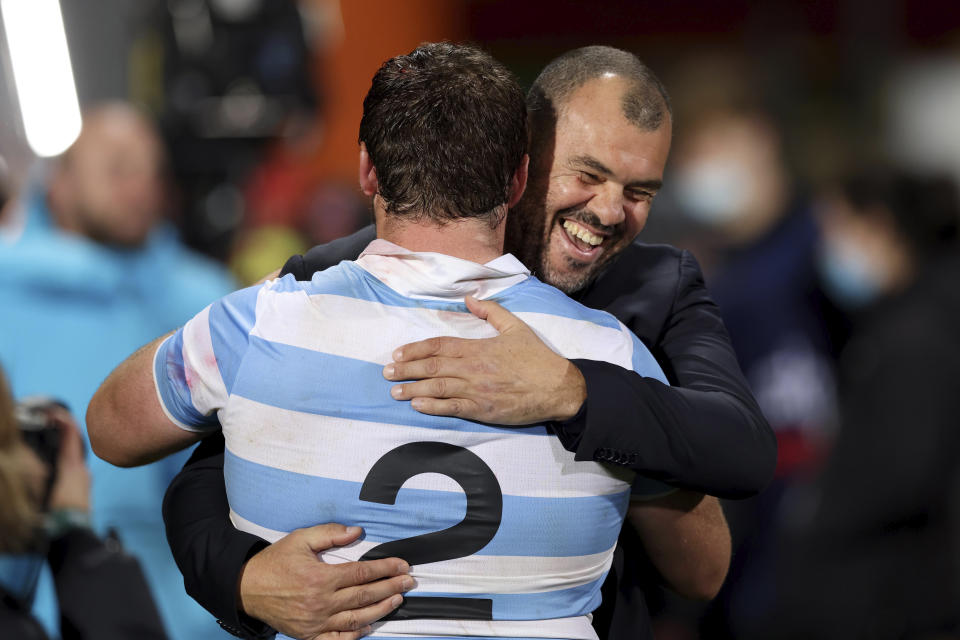Argentina head coach Michael Cheika, right, and captain Julian Montoya celebrate their win over New Zealand in their Rugby Championship test match in Christchurch, New Zealand, Saturday, Aug. 27, 2022. (Martin Hunter/Photosport via AP)