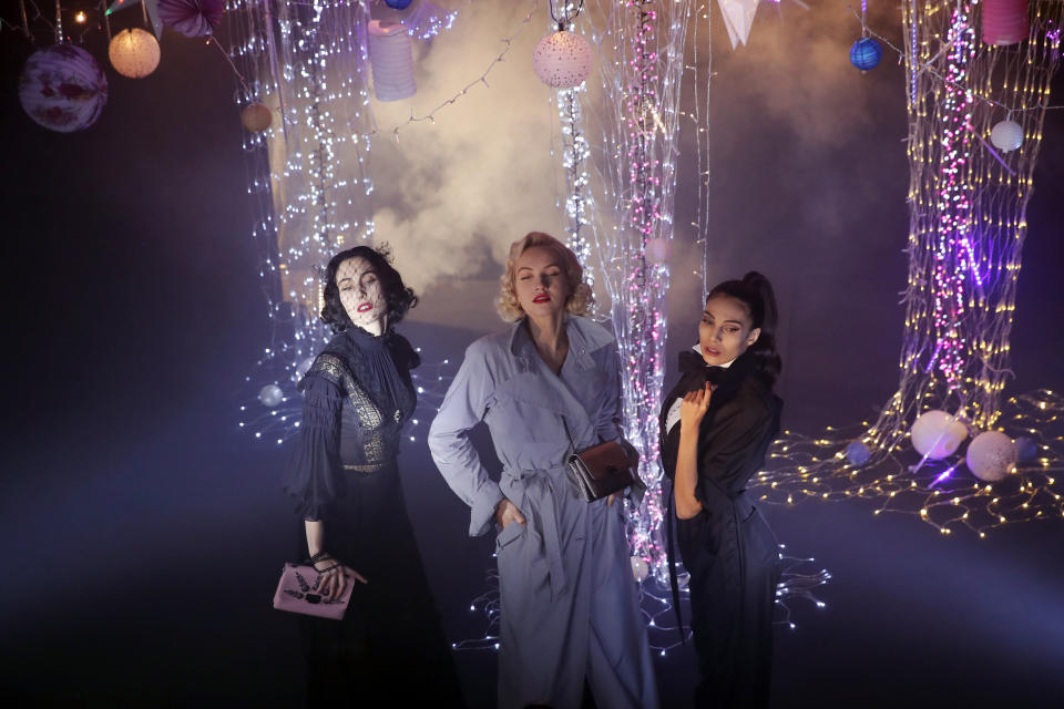 Models Angeliki Tsionou, Michaela Tomanova and Sheherazade Dakhlaoui, from left to right, display creations by Julien Fournie for his Haute Couture Spring/Summer 2021 fashion collection for a digital presentation of the fashion week, in Paris, Thursday, Jan. 7, 2021. With shows taking place behind closed doors due to the virus pandemic, some designers such as Julien Fournie are becoming versatile: Getting their designs out to the public by making a film of their collection and streaming it online. (AP Photo/Francois Mori)