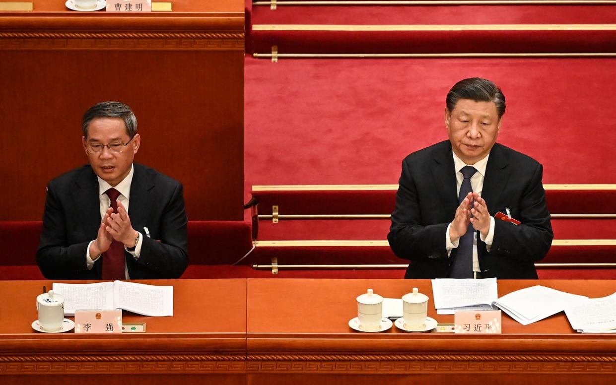 President Xi Jinping, right, says Western countries have encircled, suppressed and contained China - GREG BAKER/AFP