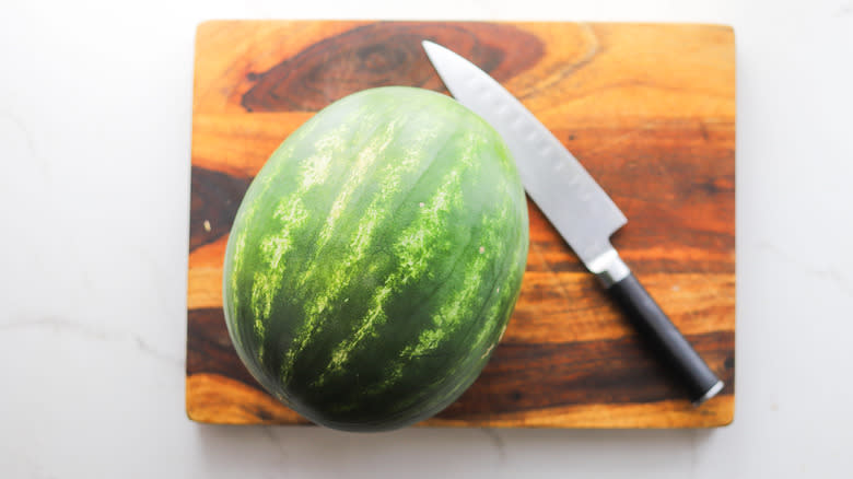 Whole green watermelon on board