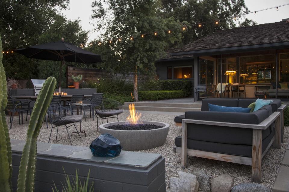 A fireplace adds to the yard's modern vibe.