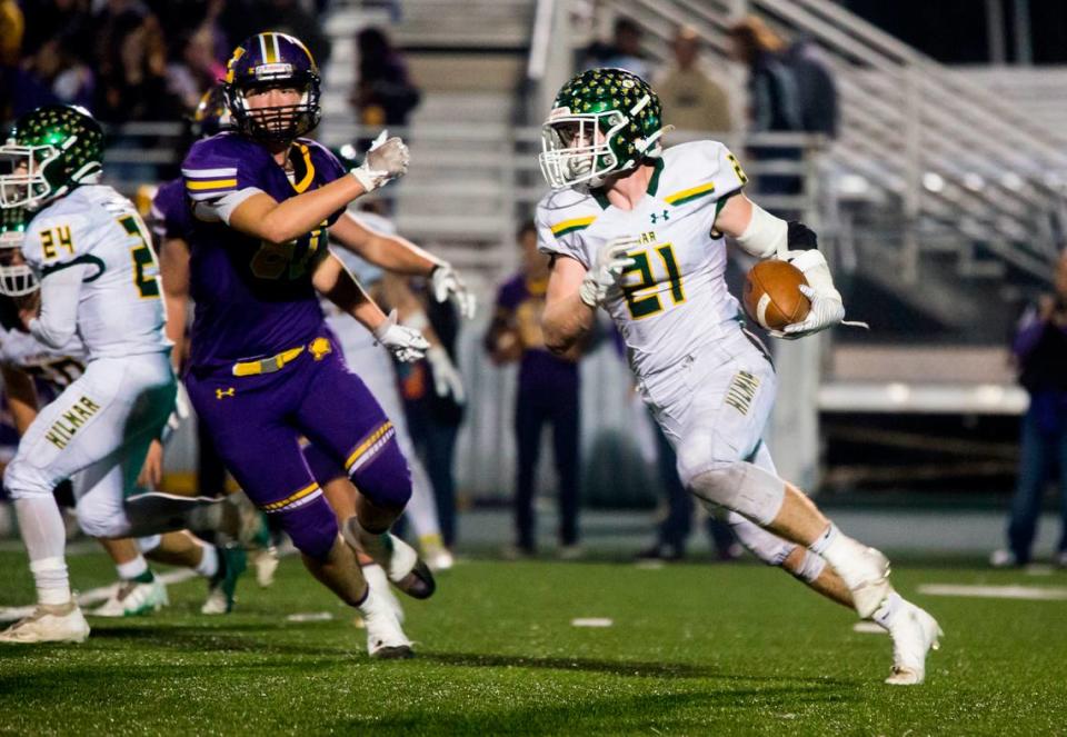 Blake Westmoreland, 21, of Hilmar High round the defense of Escalon High on his way up field. Escalon High School took on Hilmar High football during the 2021 CIF Sac-Joaquin Football Playoffs - Division V at Saint Mary’s High School in Stockton, Ca. Escalon came out on top as the champions with a 20-13 win over Hilmar.