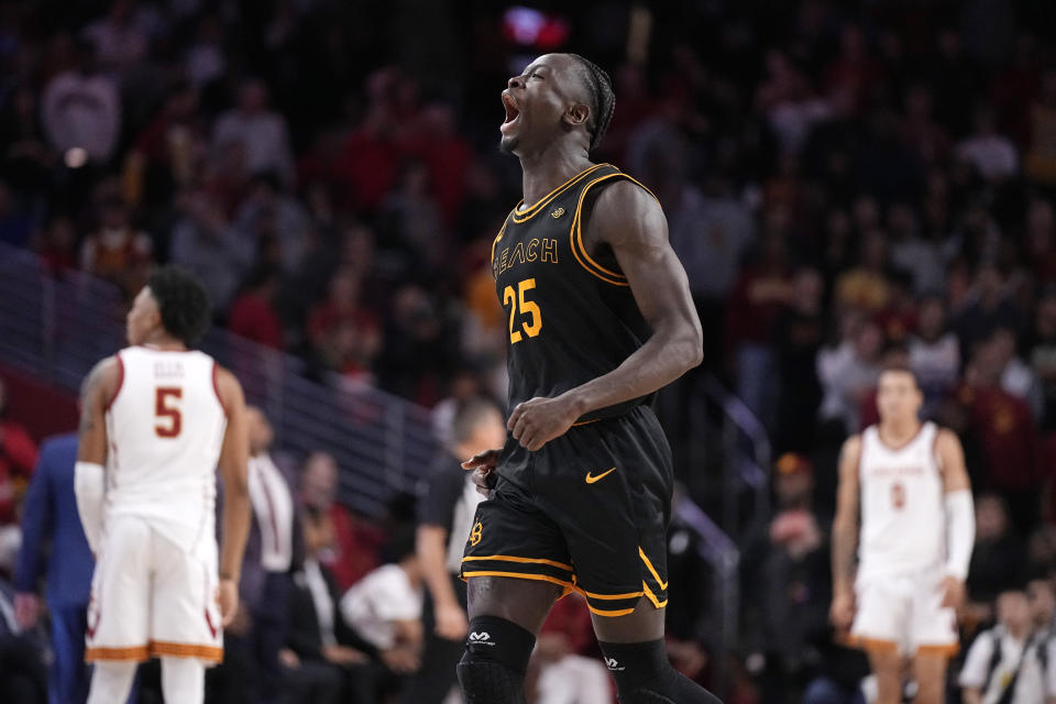 Long Beach State forward Aboubacar Traore, center, celebrates in the closing seconds during the second half of an NCAA college basketball game against Southern California Sunday, Dec. 10, 2023, in Los Angeles. (AP Photo/Mark J. Terrill)