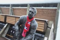 A view of a Jean Beliveau statue draped with a Montreal Canadiens scarf, is seen front of an arena named after Beliveau in Longueuil December 3, 2014. REUTERS/Christinne Muschi